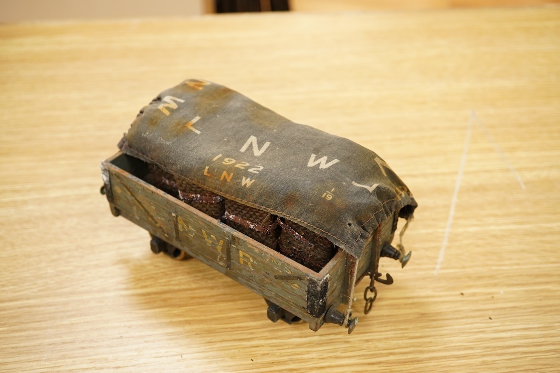 Seven Gauge One coarse scale railway freight wagons, by Bassett-Lowke, etc., including tinplate and wooden examples in liveries for LNWR, Midland Railway, and LBSCR, together with the remains of a scarce late 19th centur